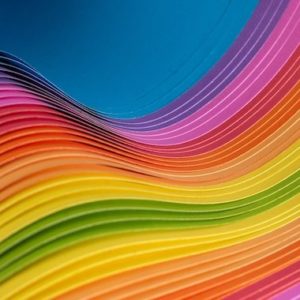 multicolored paper fanned and bent in a wave
