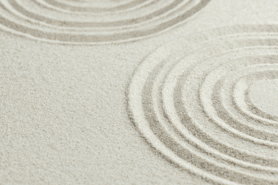 flat sand with concentric circles drawn in it like a zen garden.