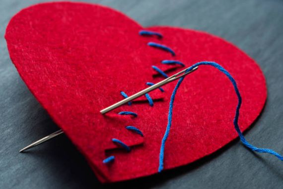 image of a felt heart that has been stitched up with a needl and thread