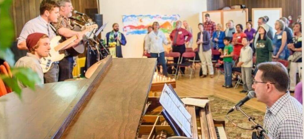 group of people playing and singing music in a church