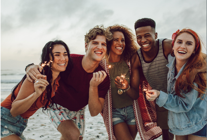 youth on a beach with sparklers